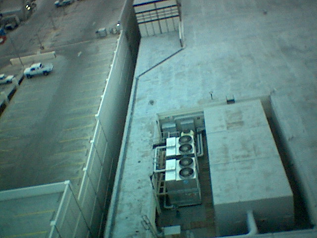 Balcony view looking down. I was afraid to throw cigarettes down there, thinking they'd get sucked into the fan and blow up the